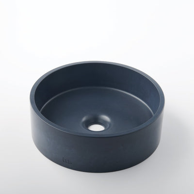 An Odet Basin SM by mudd. concrete sitting on top of a white table.
