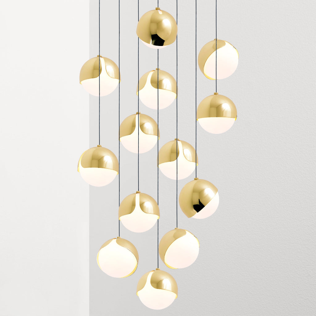 Ohm Chandelier orbiting shade allows customizable lighting directions, with opal glass orbs casting a warm ambient glow, Ohm's modular quality offers versatility.
