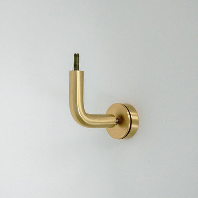 A CBH Orla Handrail Bracket on a white wall with a screw.