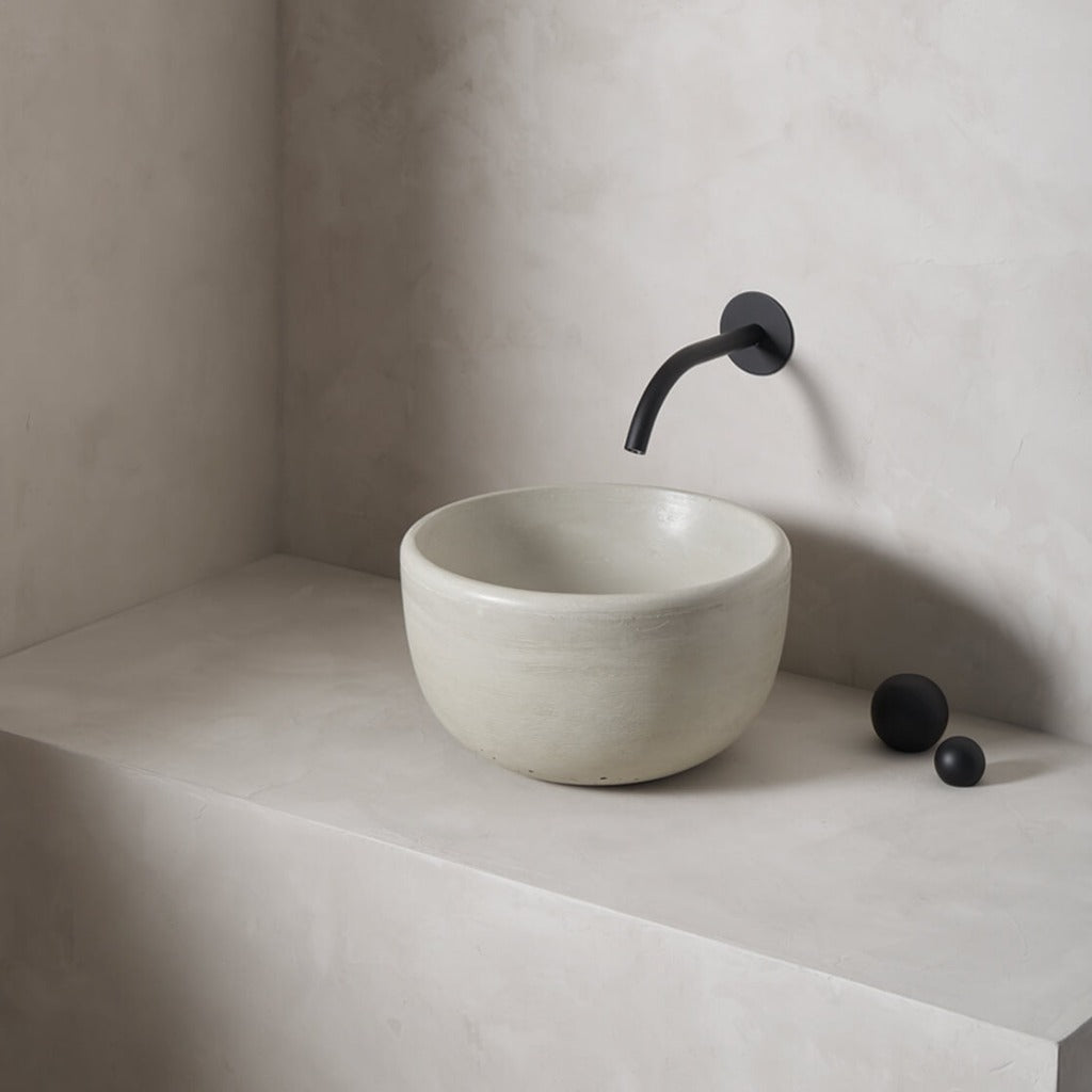 A petite and tall circular washbowl with an uplifted sink interior and round-over basin walls