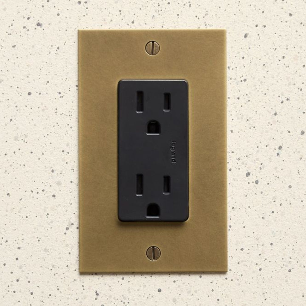 Aged brass Forbes & Lomax plate with a black US outlet.