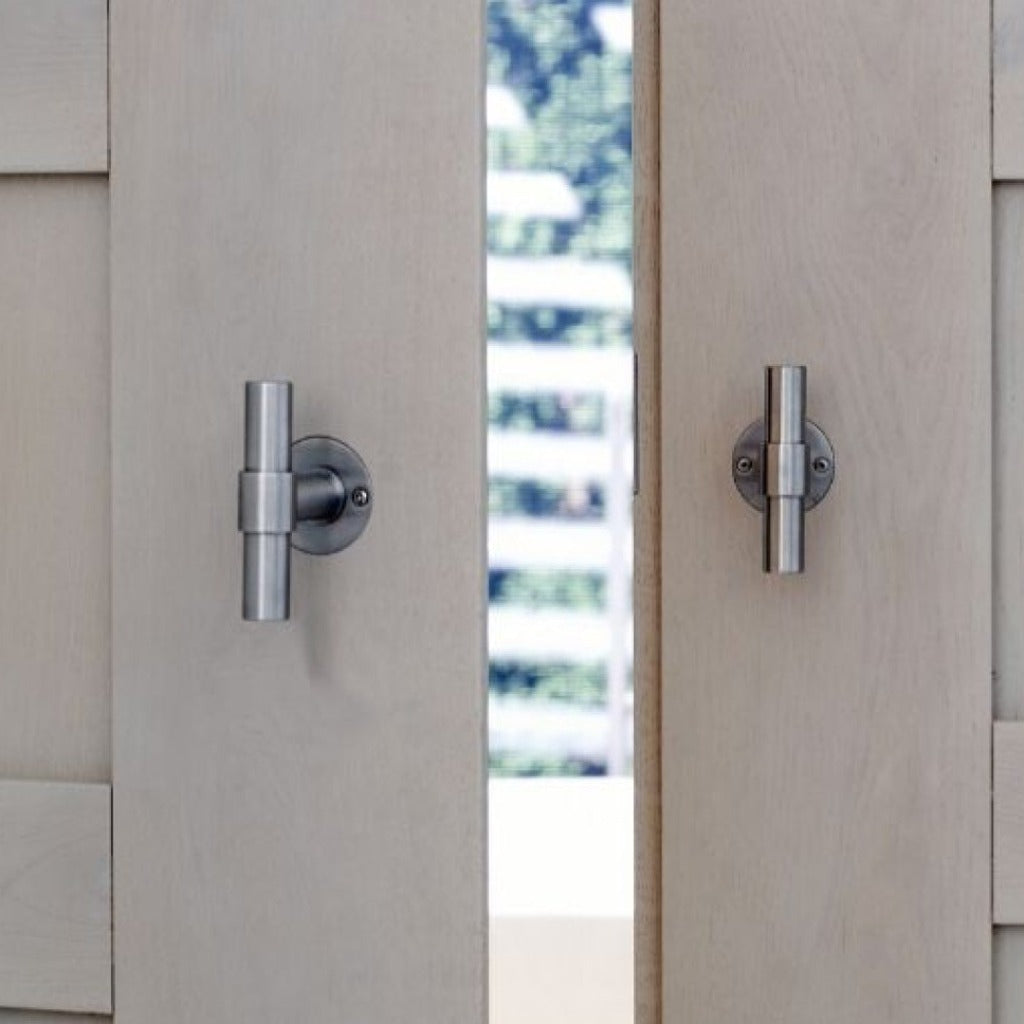 ONE by piet boon cabinet knob door handle in stainless steel on large beige doors