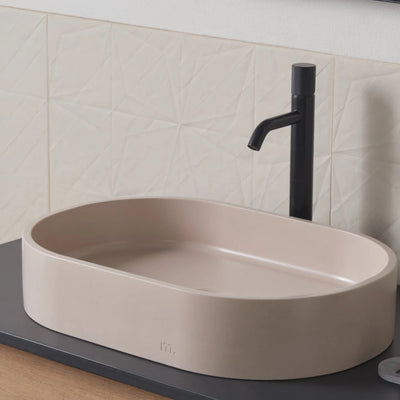 A mudd. concrete Parro Basin LG sitting on top of a counter.