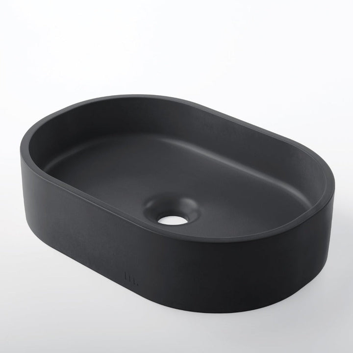 A Parro Basin SM by mudd. concrete sitting on top of a white counter.
