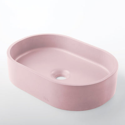 A Parro Basin SM by mudd. concrete in pink on a white background.