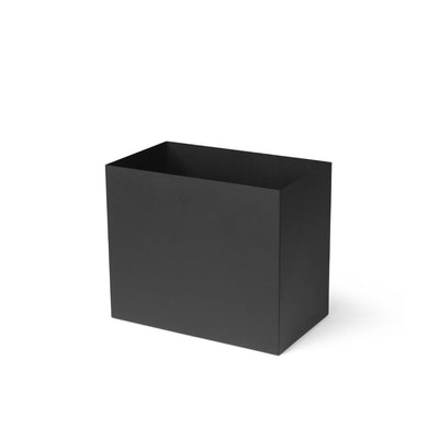 A black Ferm Living Plant Box Pot sitting on top of a white surface.