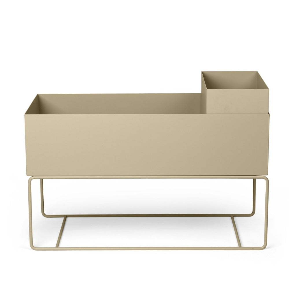 A beige Ferm Living Plant Box Pot sitting on top of a metal stand.