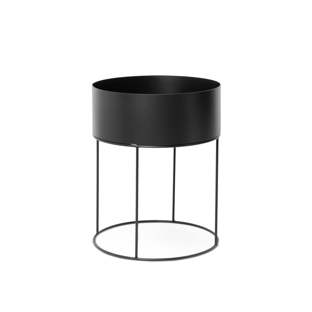 A Ferm Living Plant Box Round in black on a white background.