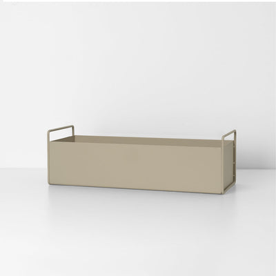 A Ferm Living Plant Box Small with a handle on a white surface.
