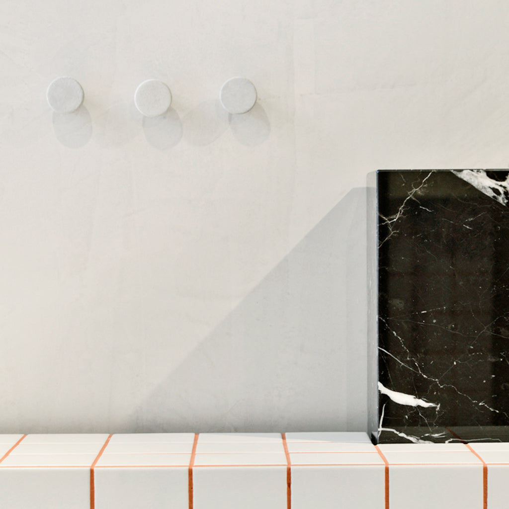 Urbi et Orbi Pomolo knobs on a white wall.
