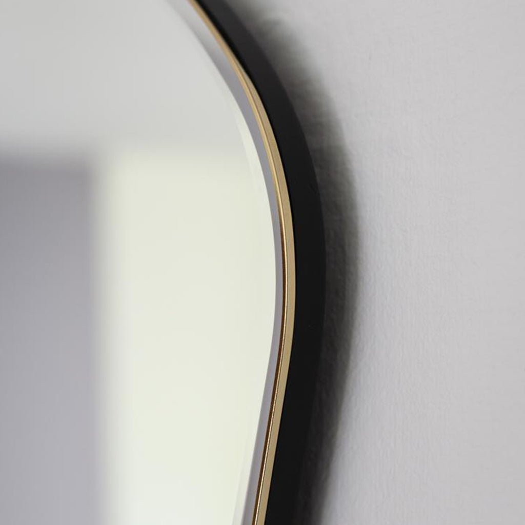A close up of a Ferm Living Pond Mirror Large on a wall.