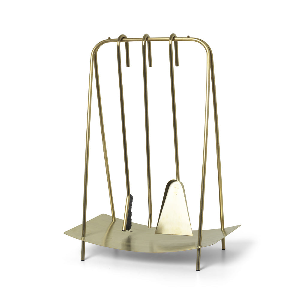 A Ferm Living Port Fireplace Tools on a metal stand with a pair of scissors.