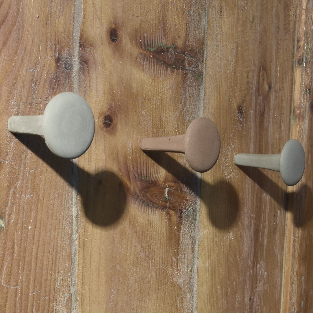 Proka concrete wall hook inspired by forged nails. A sculptural, minimalist hanger in earthy tones that brings tactile utility and modern character to any space.