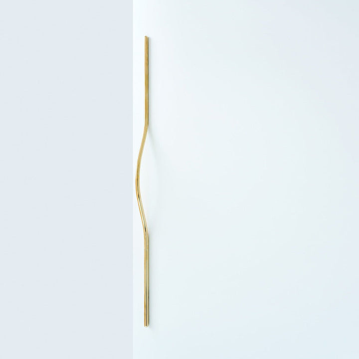 Brass line handle mounted on door