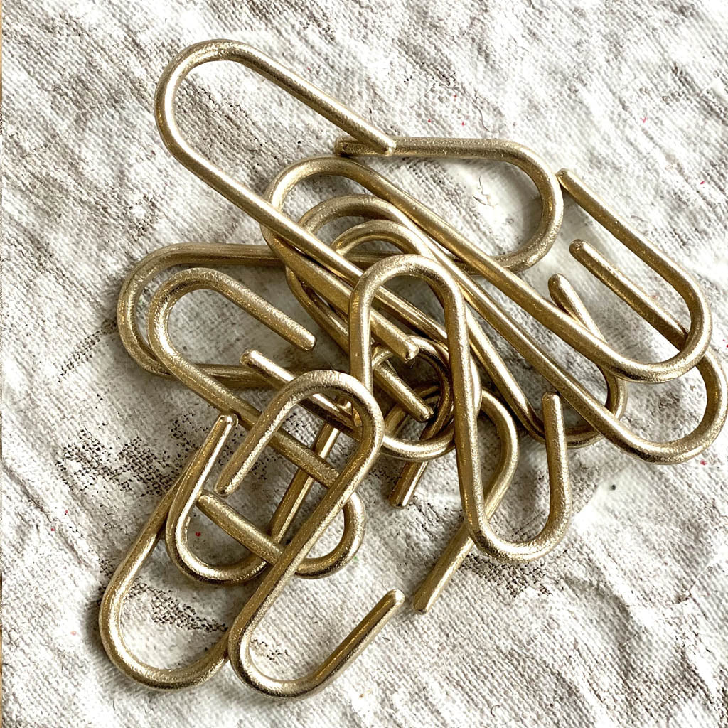 A pile of Pyra S Hooks by Shayne Fox sitting on top of a table.