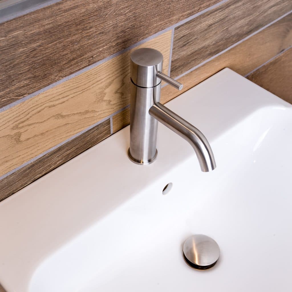 qtoo faucet by d line crafted from AISI 316 marine grade stainless steel shown here in satin stainless steel mounted in bathroom
