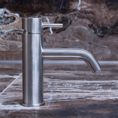 qtoo faucet by d line crafted from AISI 316 marine grade stainless steel shown here in satin stainless steel mounted in bathroom on marble counter
