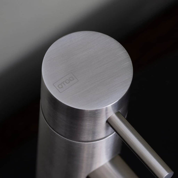 qtoo faucet by d line crafted from AISI 316 marine grade stainless steel shown here in satin stainless steel mounted in bathroom