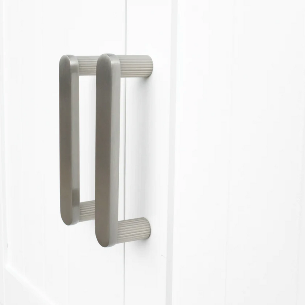 Ribbed cabinet pull in satin nickel.