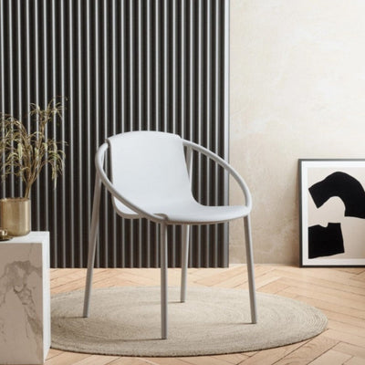 An Umbra Ringo Chair sitting on top of a wooden floor.