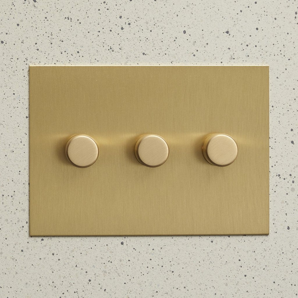 Aged brass Forbes & Lomax plate with three rotary dimmers.