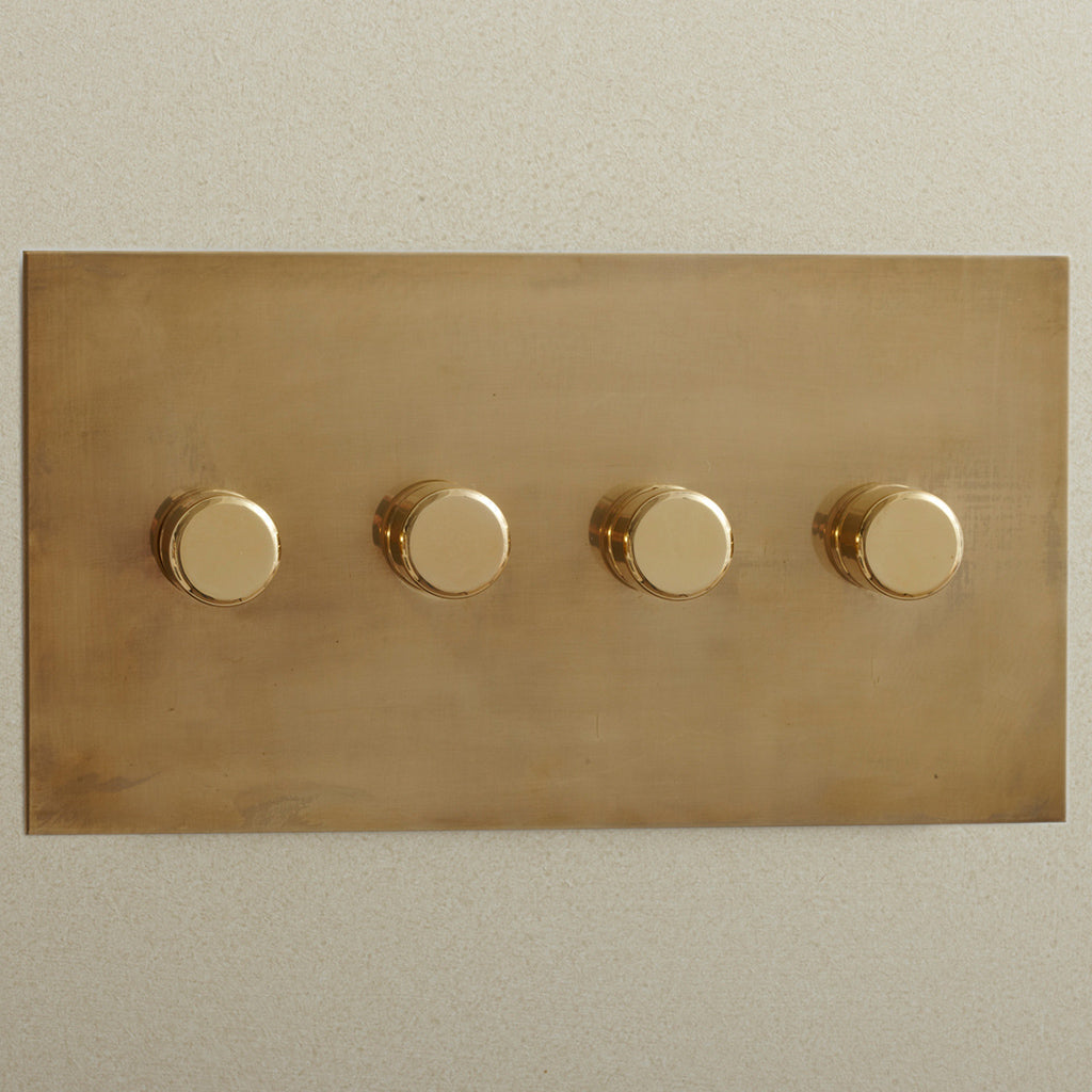 Forbes & Lomax three gang rotary dimmer plate, angled view.