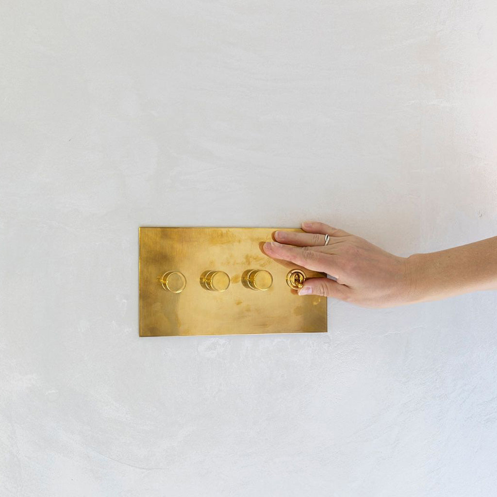 Metal plate rotary dimmer by Forbes & Lomax in unlacquered brass.