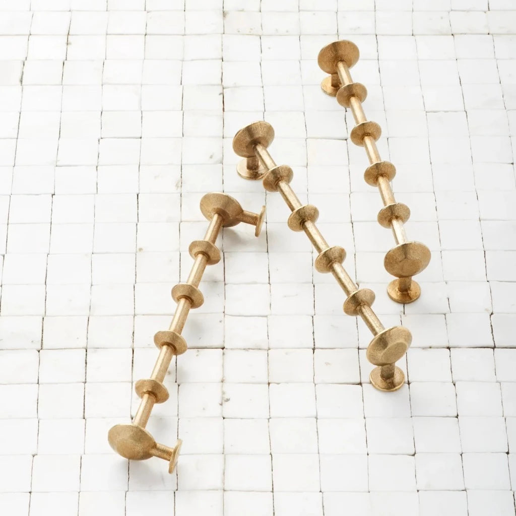 SPUL Handles in satin brass on tile surface