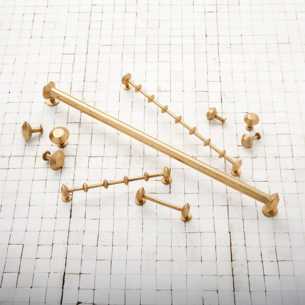 SPUL Handles in satin brass on tile surface