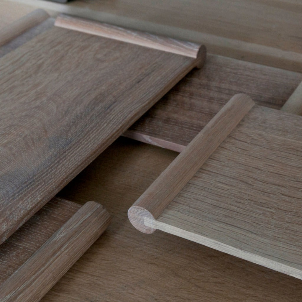 A group of rectangular wooden trays laid over each other