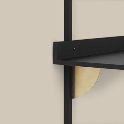 A close up of a Ferm Living Sector Desk on a wall.