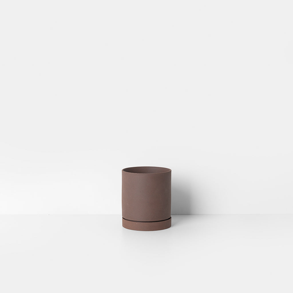 A Sekki Pot by Ferm Living sitting on top of a white table.