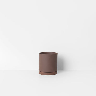 A Sekki Pot by Ferm Living sitting on top of a white table.