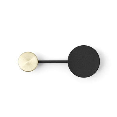 A black and gold Audo Small Afteroom Coat Hanger on a white wall.