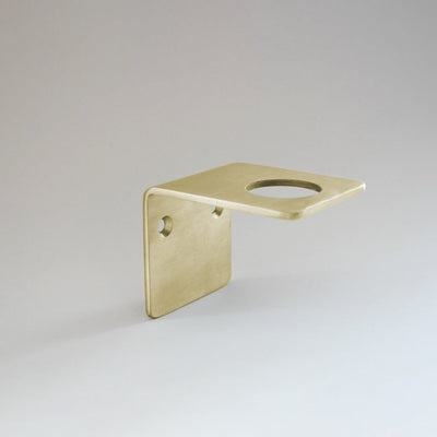 Satin brass wall bracket of soap, cream and hand sanitizer.