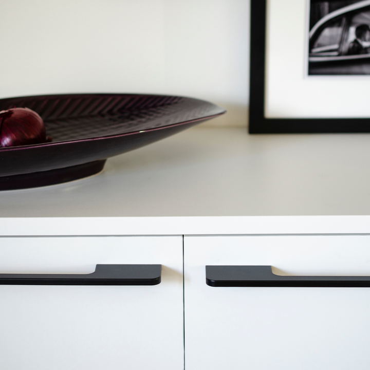 A Soft Cut Handle bowl from Baccman Berglund with an apple in it sitting on a counter.