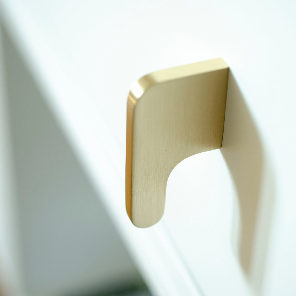 A close up of a Soft Cut Knob by Baccman Berglund on a white door.