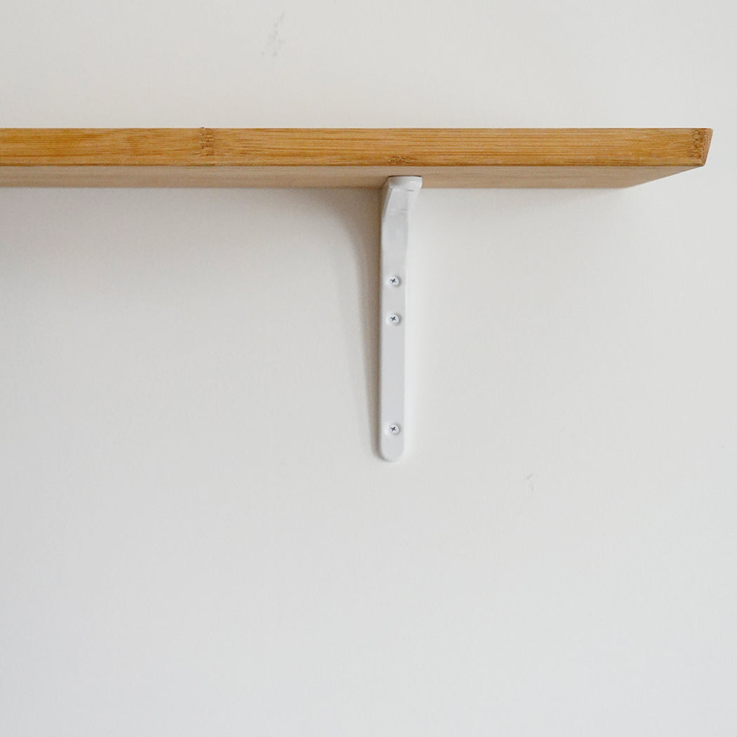 A Sugatsune shelf bracket with a white object on it.