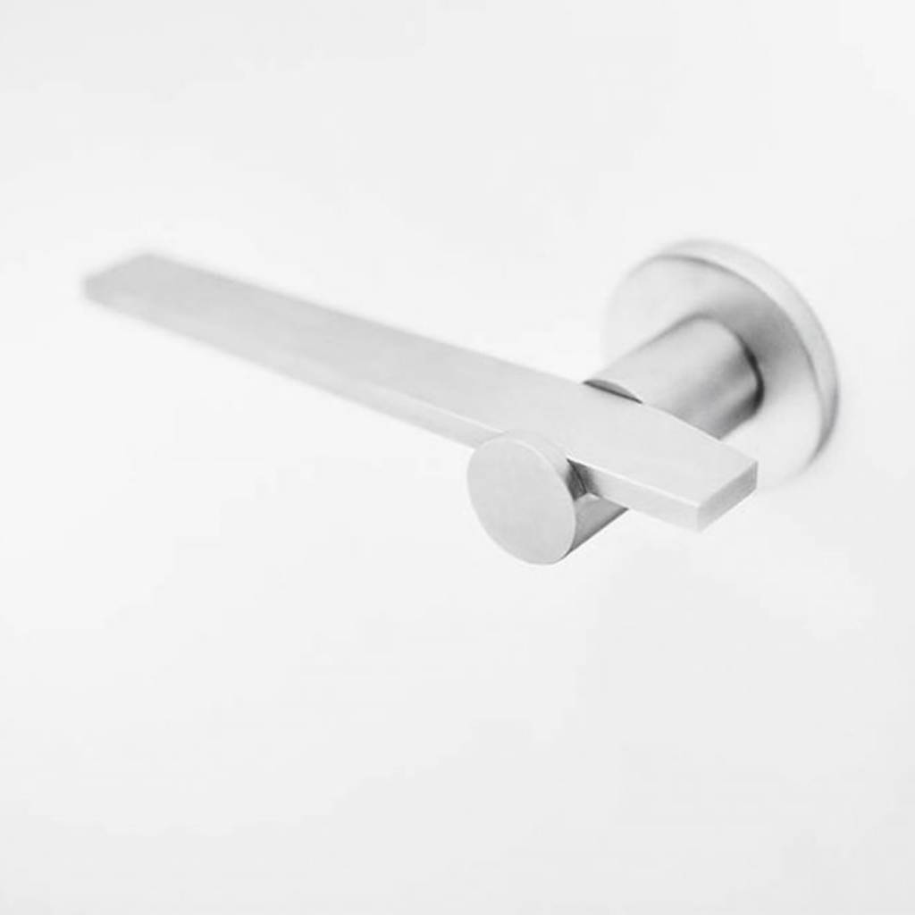 A close up of a Formani TENSE BB100G door lever on a door.