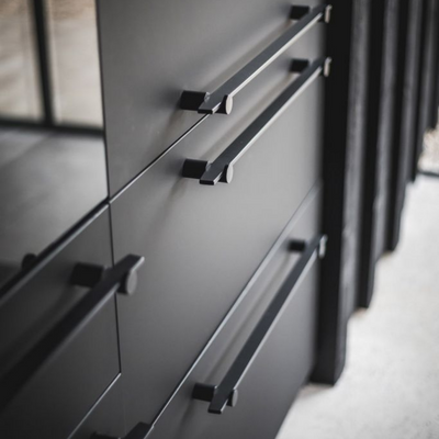 A close up of a drawer with Formani TENSE BB25 160/320 Cabinet Handles on it.