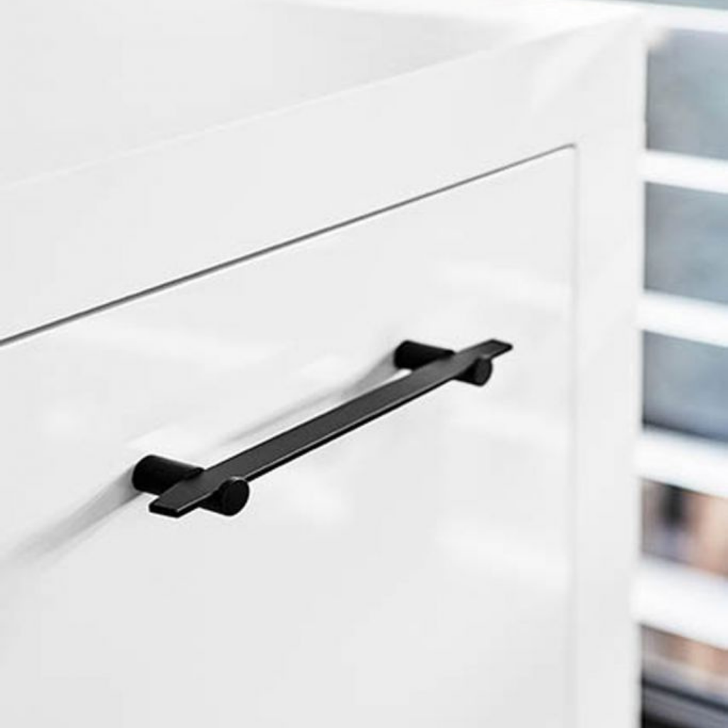 A close up of a white cabinet with Formani TENSE BB25 160/320 Cabinet Handles.