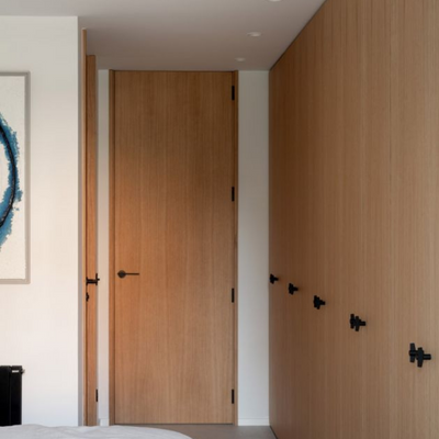 A bedroom with a bed and a Formani TENSE BB25 M Cabinet Knob on the wall.