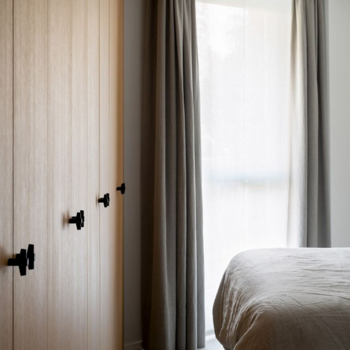 a bedroom with a Formani TENSE BB25 M Cabinet Knob bed, curtains, and a window.