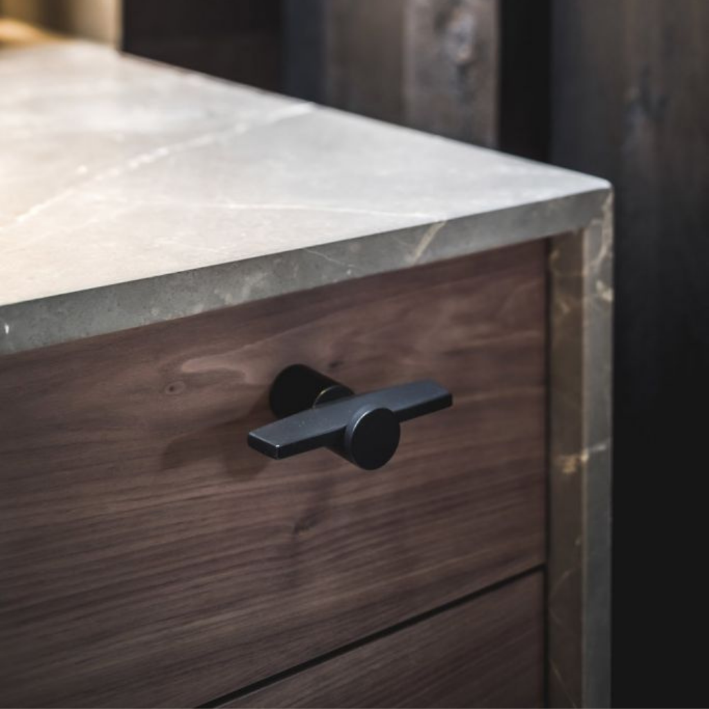 A close up of a drawer with a Formani TENSE BB25 M Cabinet Knob on it.