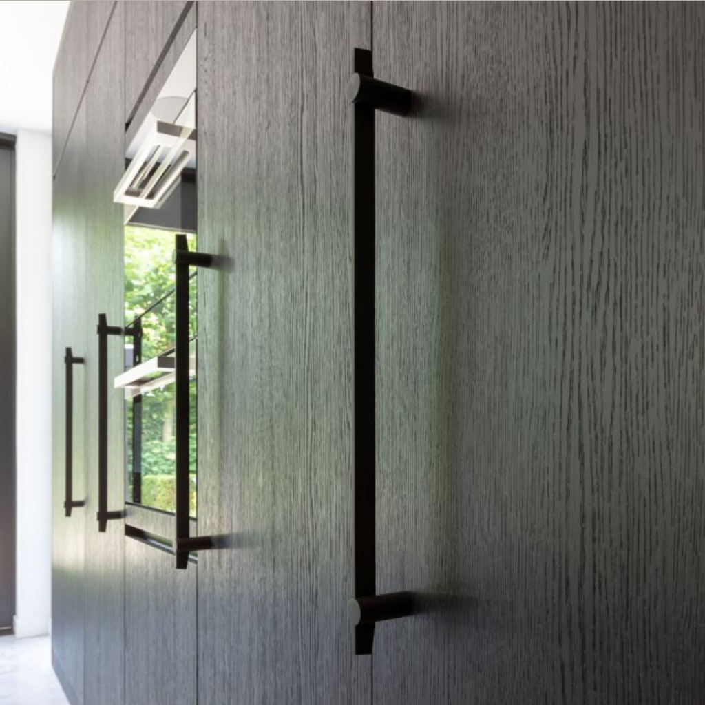A wooden wall with a Formani TENSE BB500 Pull Handle on it.