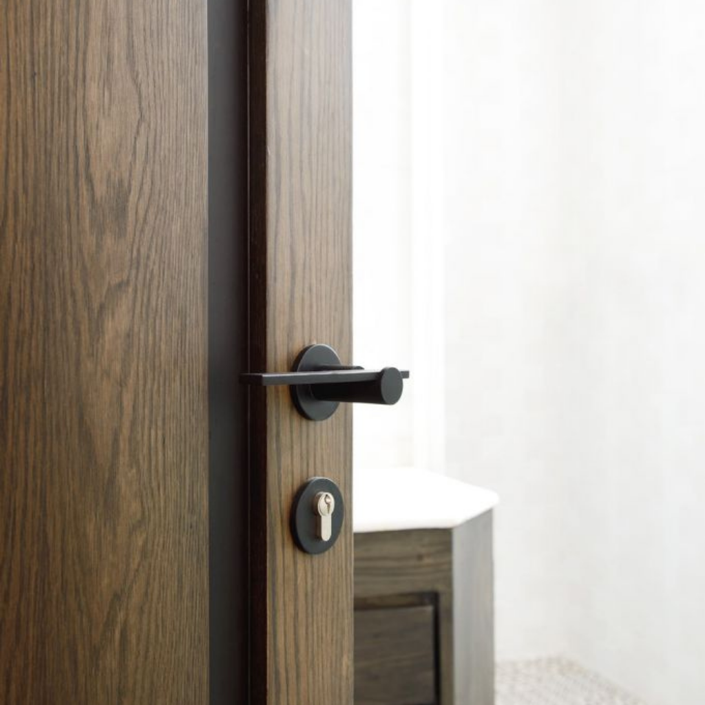 A close up of a Formani TENSE BBY53 Escutcheon on a wooden door.