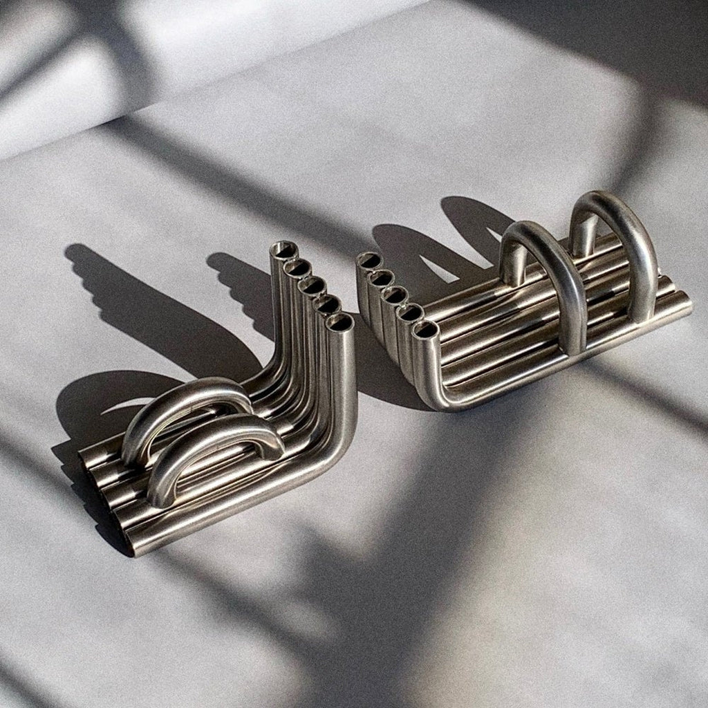 Stainless Steel TUBE bookends in a white background with long shadows 