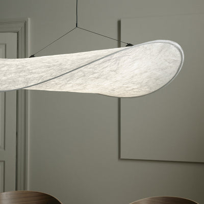 A New Works Tense Pendant Lamp hanging from a ceiling in a room.