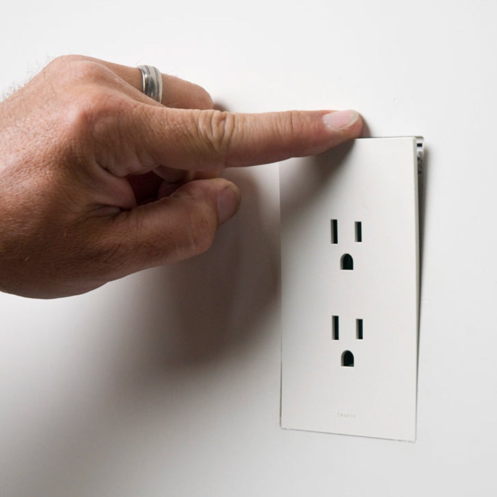 A hand is pointing at a Trufig Leviton Fascia Electrical Outlet.