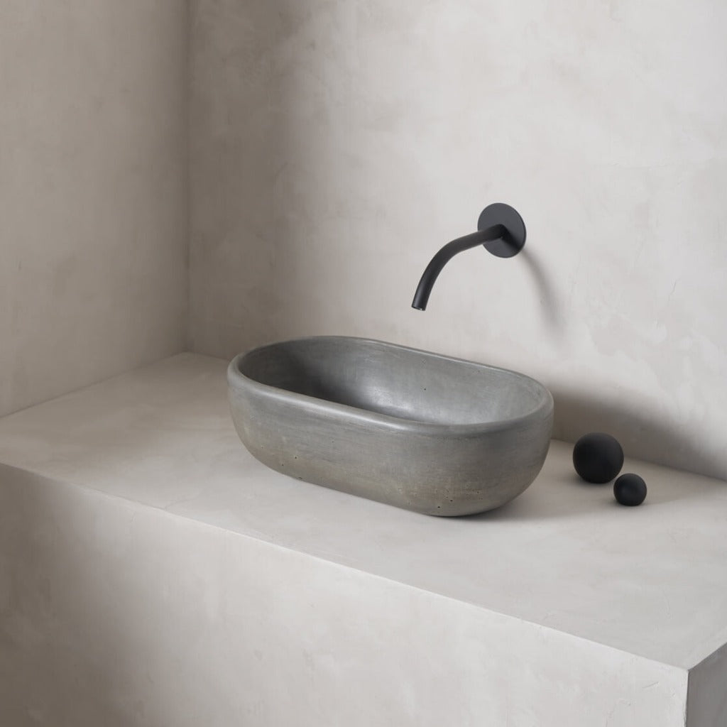 A petite and obround washbowl with softened curves and high, round-over basin walls